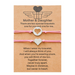 2 pink heart string bracelets with a message card