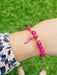 girl wearing pink bead bracelet