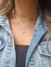 girl wearing double necklace with cross