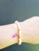 light pink bead bracelet qith hot pink horn charm