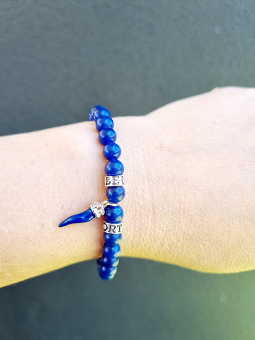 blue bead bracelet with horn charm