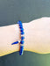 blue bead bracelet with horn charm