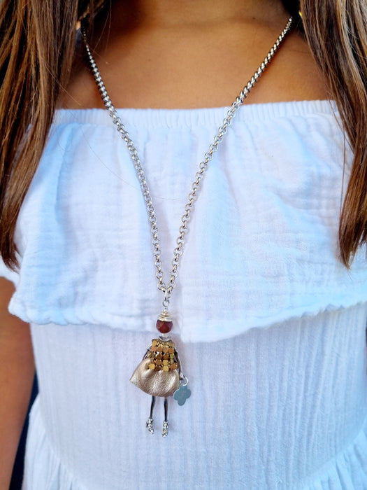 girl wearing doll chain necklace