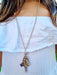 girl wearing long doll chaim silver necklace