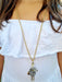 girl wearing gold spotty doll necklace