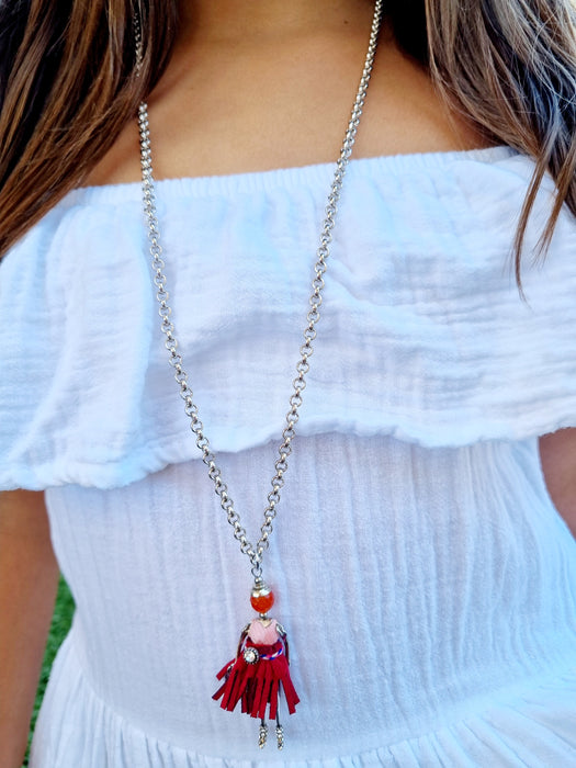 girl wearing silver doll necklace