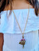 girl wearing gold long chain doll necklace