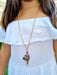 girl wearing doll chain necklace