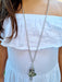 girl wearing silver doll chain necklace