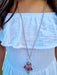 girl wearing silver doll chain necklace