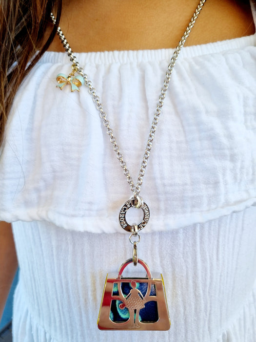 girl in white dress wearing silver long necklace