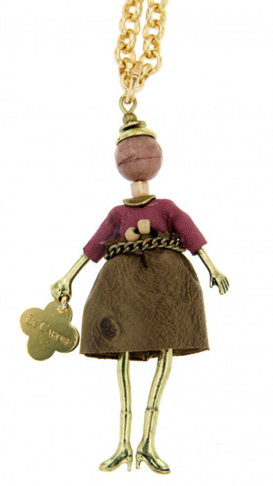 long gold chain necklace with doll pendant. Doll features brown leather-like skirt, purple sweater and chain belt