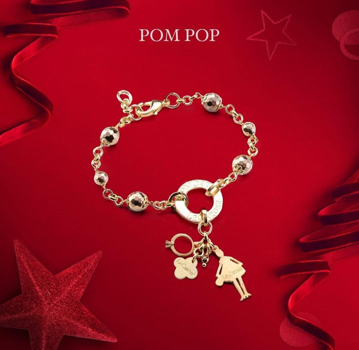 gold ladies charm bracelet on red christmas theme background.